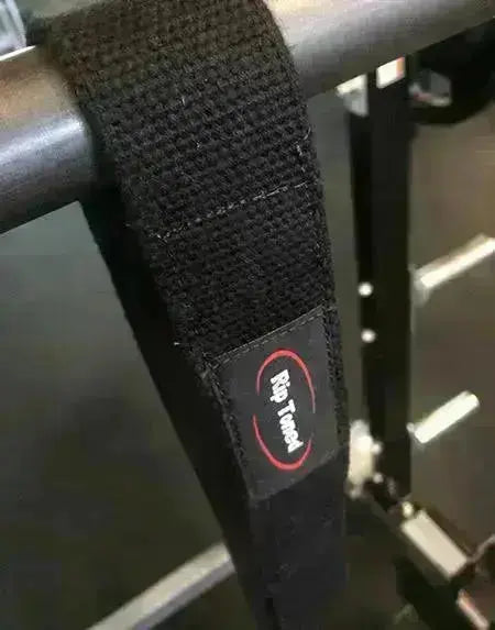 Black Rip Toned wrist wraps and lifting straps placed on bench