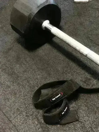 Olive green Rip Toned wrist wraps and lifting straps on wood floor