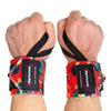 Two hands wear Rip Toned Wrist Wraps: Stiff and Flex by Rip Toned in Large Flower color, viewed from above. These wraps offer serious wrist support for powerlifters tackling heavy lifts.